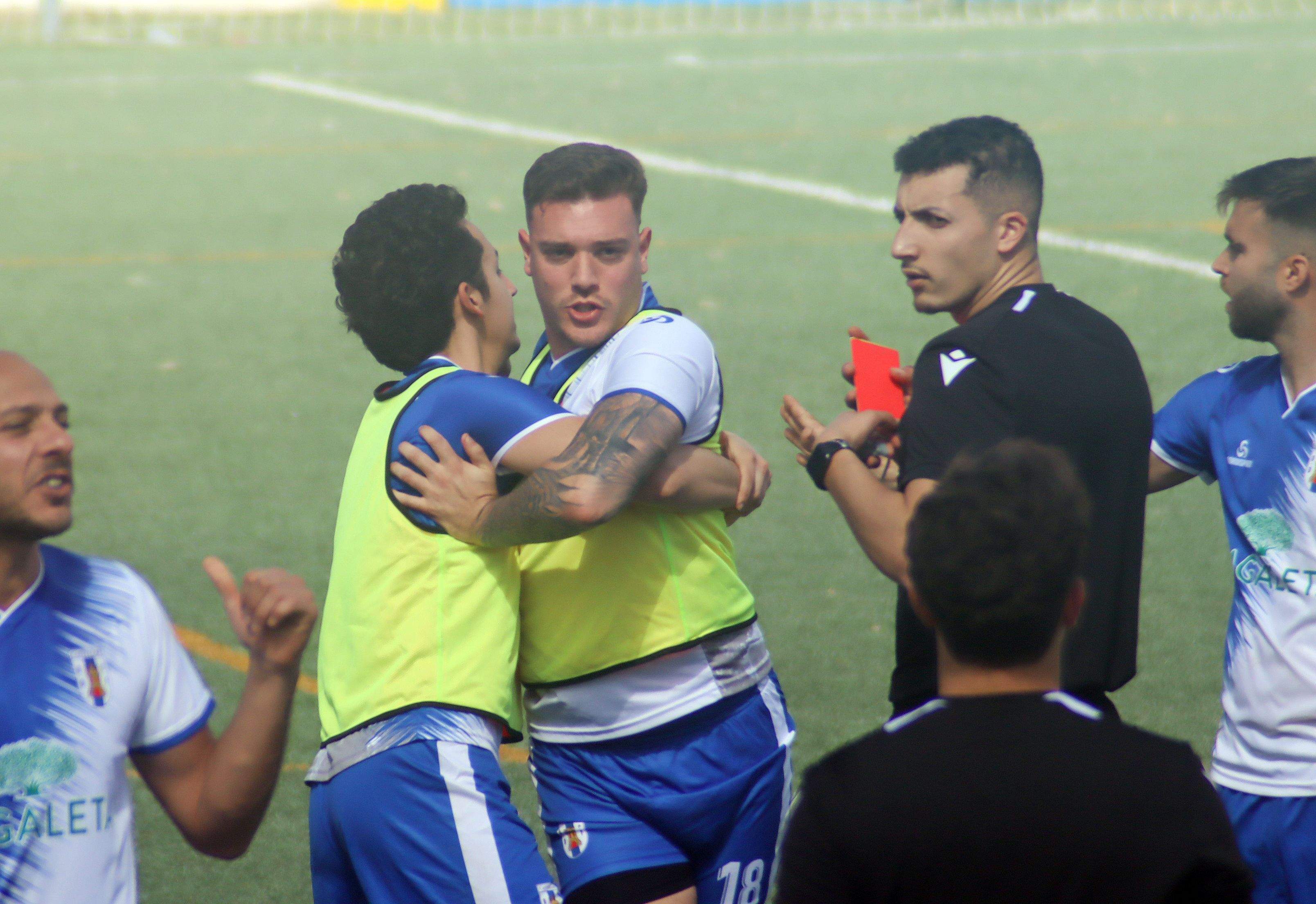 El jugador de la UD Castellar CF, Adrián López, sujetado por un compañero, muestra su enfado tras ser expulsado ante el CD San Bernardo/Foto: Axel S.C.