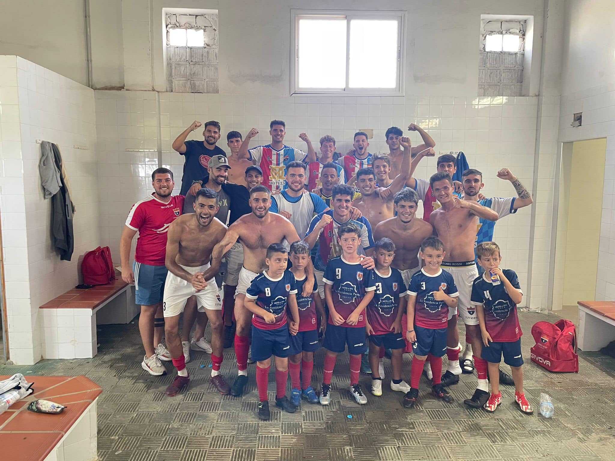 Los jugadores de la UD Tarifa festejan el triunfo con uno de los equipos de cantera de la AD Guzmán el Bueno