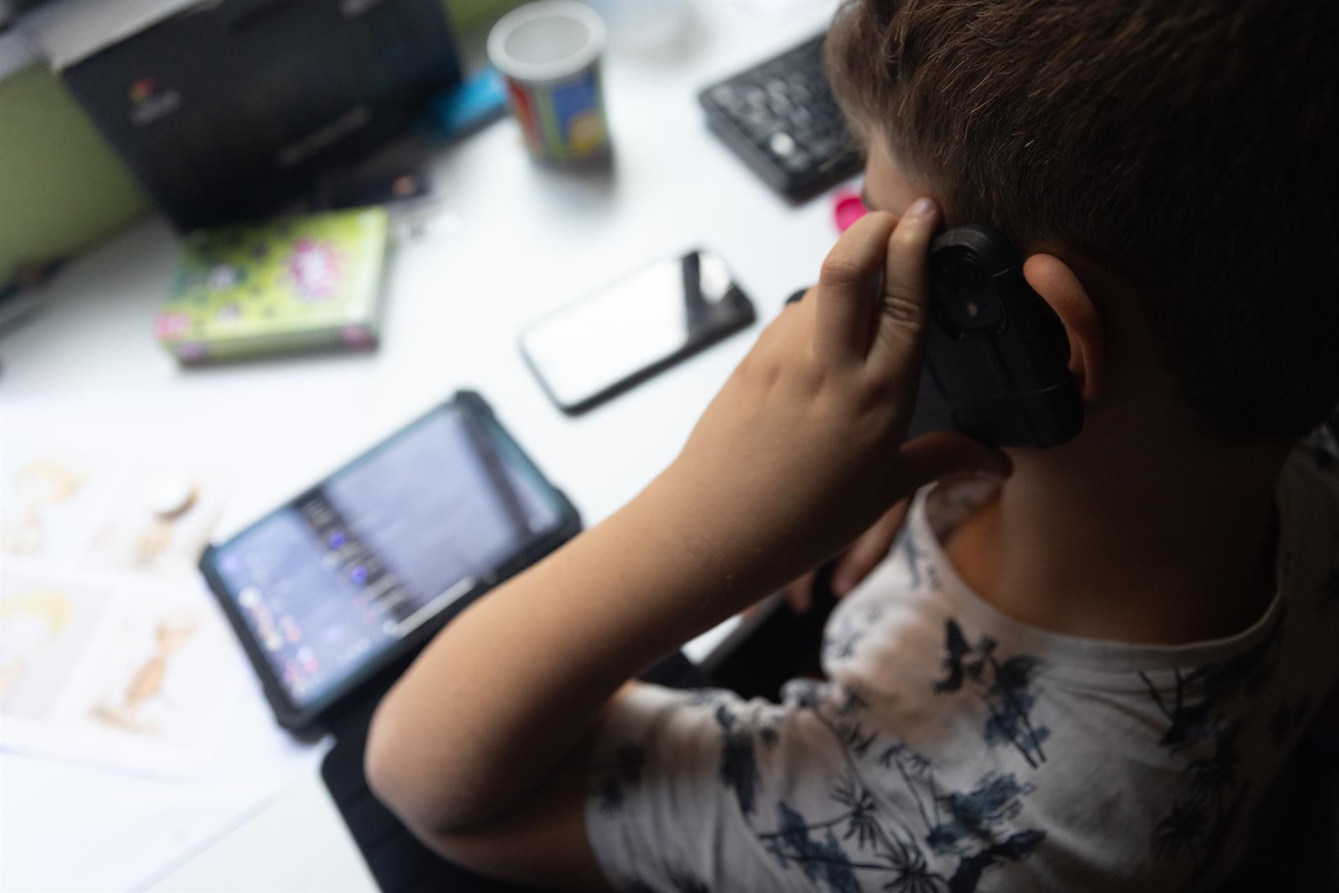 Andalucía permitirá retirar el móvil a los alumnos que no respeten los límites de uso. Un niño usa el teléfono móvil y una tablet, foto de recurso - Eduardo Parra - Europa Press - Archivo.