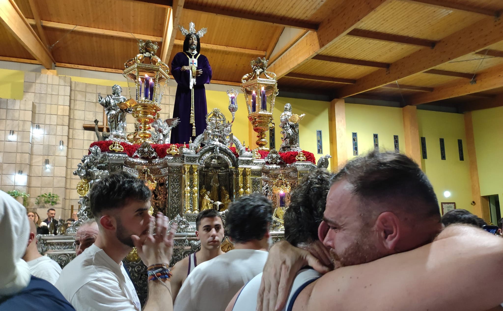 La emoción inunda el interior de las parroquias en un lluvioso Miércoles Santo. Dos costaleros se abrazan ante el Medinaceli. Foto: S.D. / 8Directo.